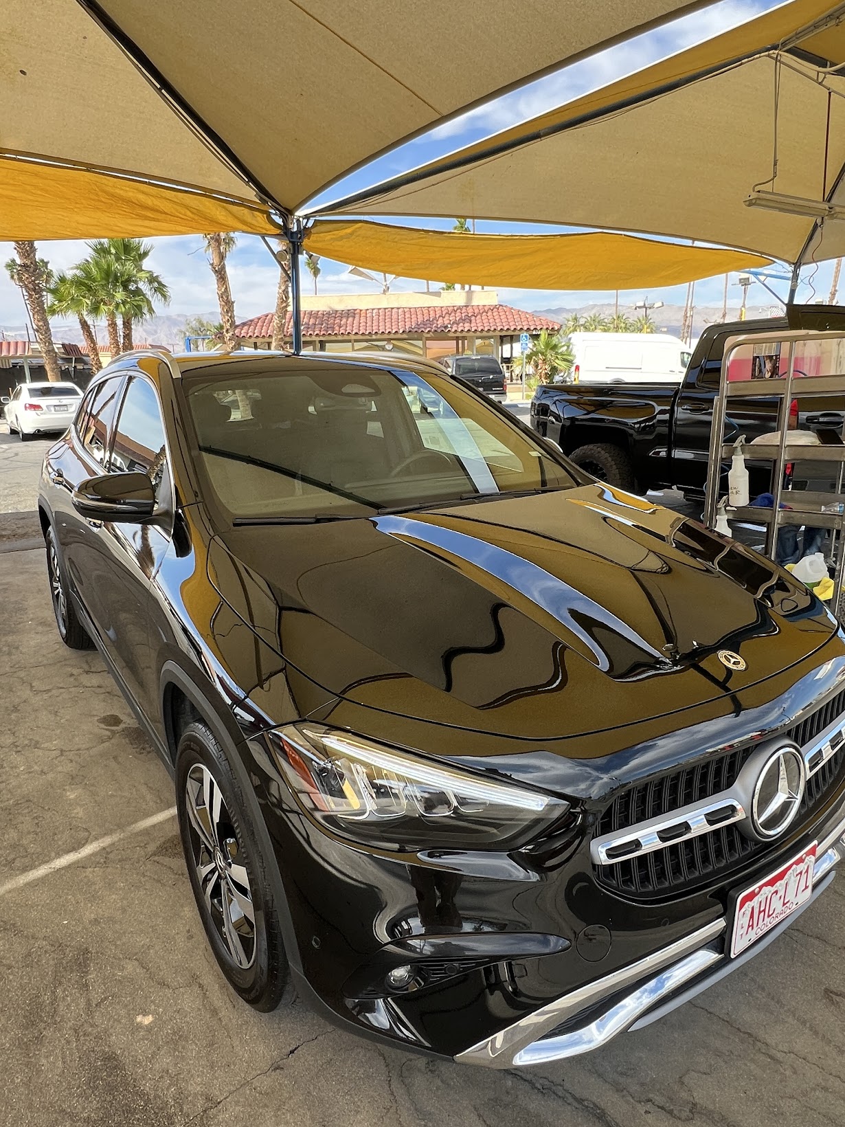 Clean black Mercedes GLA after exterior wash